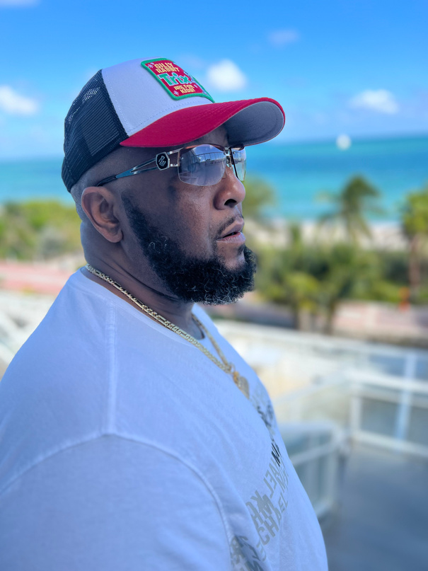 Big Tone P portrait, profile shot in white tee