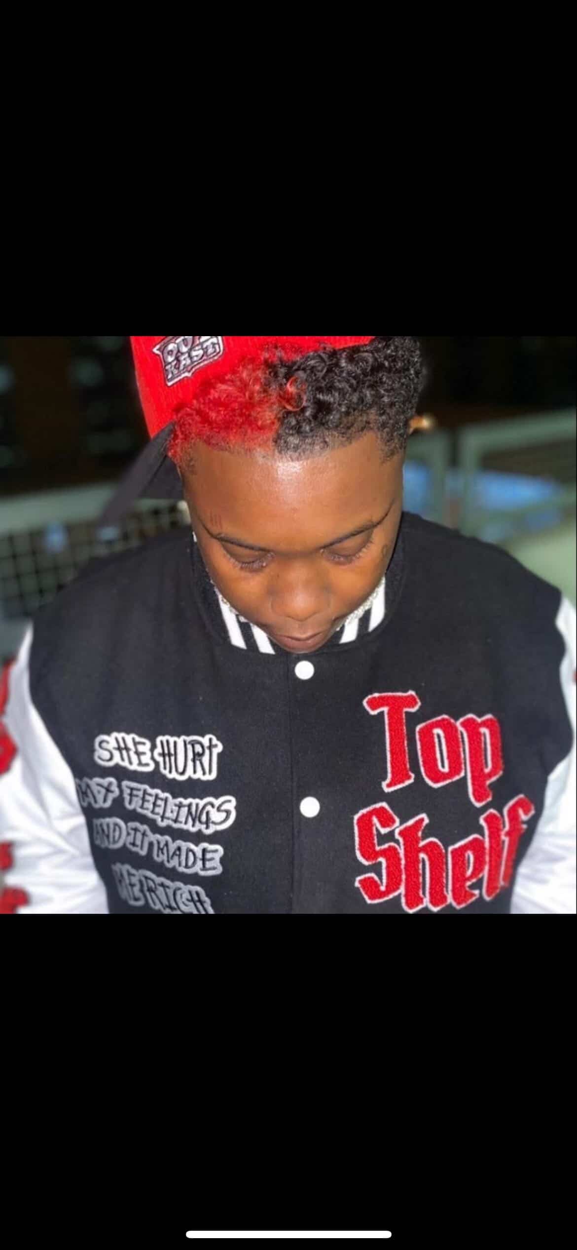 Booga Brim in Outkast cap and Top Shelf letterman jacket, head down